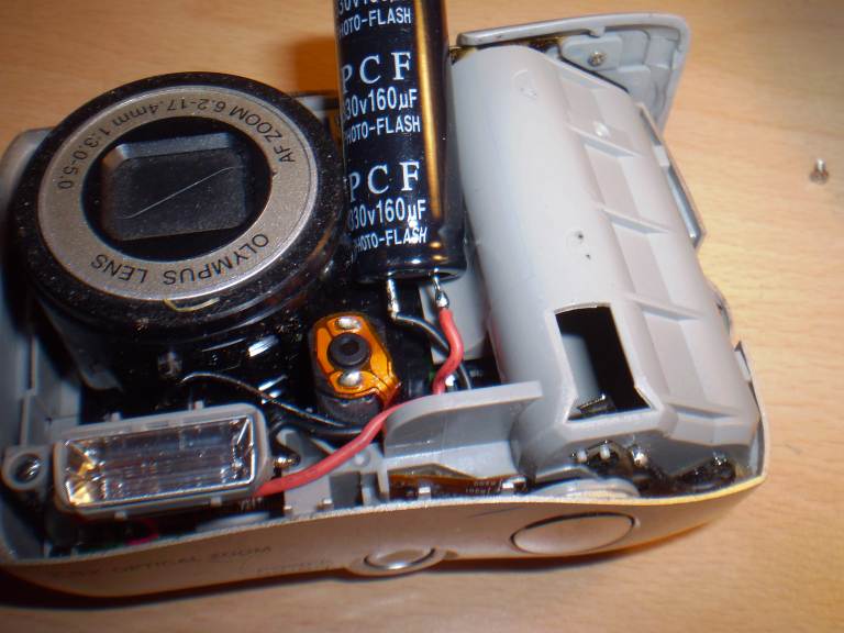 Camera with exposed capacitor